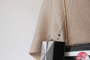 Detail of 3mm gold metal flat snake chain strap on acrylic clutch with flamingo pattern