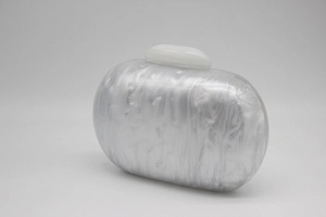 Close-up of marble pattern white acrylic clutch bag with a rectangular top clasp