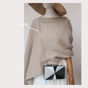Detail showing the 120cm silver metal chain on a marble patterned crossbody clutch bag
