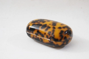 Detailed top view of a round acrylic clutch bag featuring stylish leopard print finish