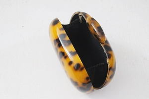 Detail showing the inner lining and open structure of leopard print acrylic evening bag