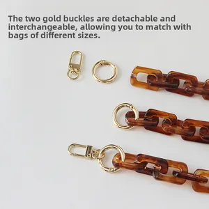 Detail of amber acrylic chain strap with detachable gold lobster and ring clasps