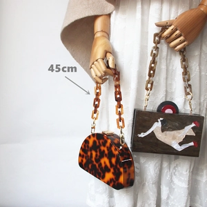 Detail shot of 45cm acrylic resin chain strap on vintage tortoiseshell crossbody bag