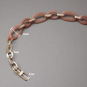 Detail view of pink resin acrylic and gold metal chain strap with dimension markings