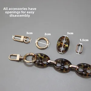 Detail of leopard resin chain link with golden spring clasps and disassembly components