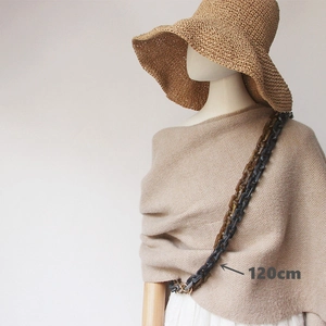 Detail of 120cm acrylic chain strap in amber and matte grey with gold metal clasps