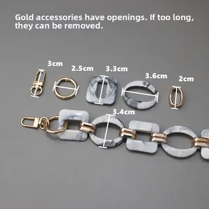 Detail view of detachable marble resin chain with adjustable gold metal rings and lobster clasps