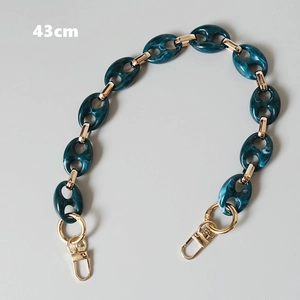 Close-up of 43cm marble green acrylic resin links with gold metal clasp for handbag