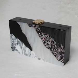 Acrylic black and white marble clutch bag with gold clasp and glitter stars decoration