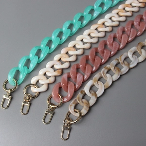 Detail view of chunky resin purse chains in four marble colors with gold metal clasps
