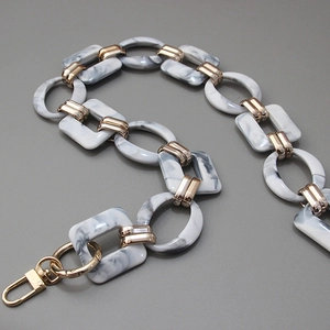Detail of vintage acrylic resin chain with marble texture and gold lobster clasp for bags