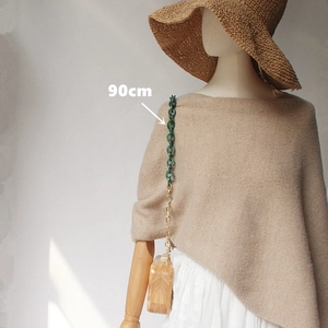 Detail of 90cm acrylic and gold metal chain strap on a wooden box bag for women