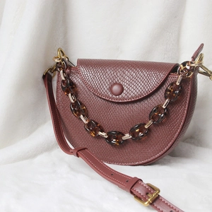 Snake pattern saddle bag in wine red featuring a vintage tortoiseshell resin chain