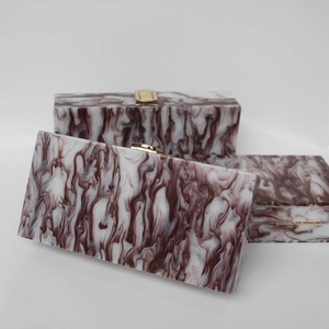 Three elegant wine red marble textured acrylic clutch bags with golden metal clasps