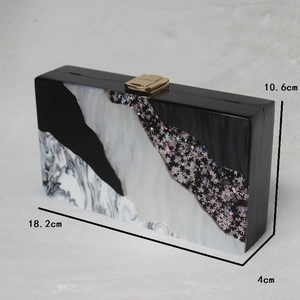 Detail view showing dimensions of black and white marble acrylic clutch with star sequins
