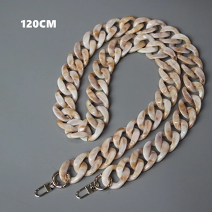 Detail of 120cm acrylic resin bag strap with marble texture and golden metal clasps