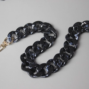 Detail of chunky marble texture acrylic bag chain with gold lobster clasps and rings