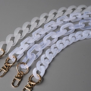 Detailed macro view of acrylic resin chain straps with marble patterns and gold lobster clasps