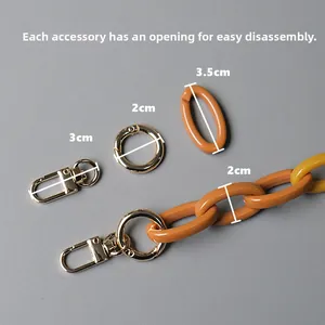 Detail view of detachable orange and yellow acrylic resin bag chain with metal buckles