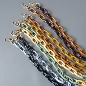 Detail view of colorful acrylic resin bag chains with gold metal lobster clasps