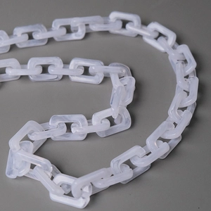 Macro shot of milky white acrylic resin chain links with marble texture for handbags