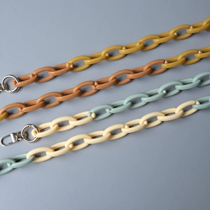 Detailed close-up of colorful acrylic resin chunky bag chains with silver metal buckles
