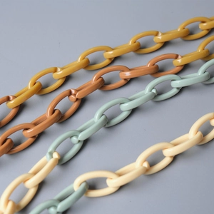 Detail view of colorful acrylic resin chain links in yellow, brown, green and beige