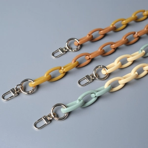 Detailed macro view of colorful acrylic resin chain links with silver metal lobster clasps