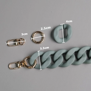 Detail view of matte sage green acrylic bag chain links with gold hardware dimensions