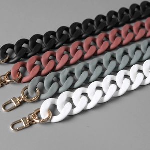 Macro shot of colorful matte acrylic resin bag straps with gold metal lobster clasps