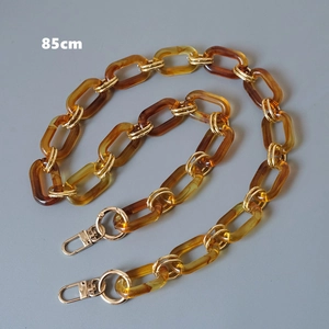 Detail of 85cm amber acrylic chain strap with gold metal clasps for shoulder bags