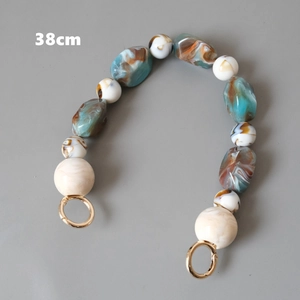 Detail of 38cm vintage resin bead handle with blue and brown marble texture and gold clasps