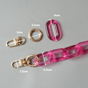 Detail of rose pink acrylic chain links with gold spring rings and metal lobster clasps