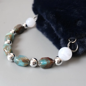 Close-up of vintage ink resin bead chain with marble texture and silver metal ball