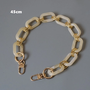 Detail view of 45cm cream resin and gold metal link chain strap with lobster clasps