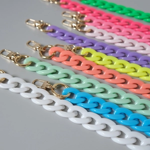 Close-up of vibrant acrylic fishbone chains with golden metal lobster clasps for bags