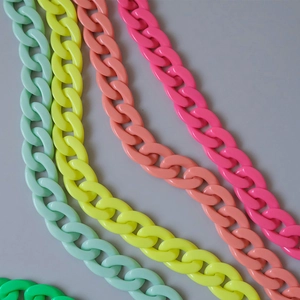 Macro detail of chunky acrylic resin chains in vibrant candy colors and matte finish