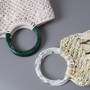 Detail of DIY woven handbag featuring round marble-textured resin ring handles