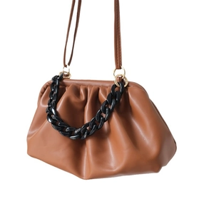 Caramel brown dumpling bag with decorative chunky black acrylic chain and thin strap