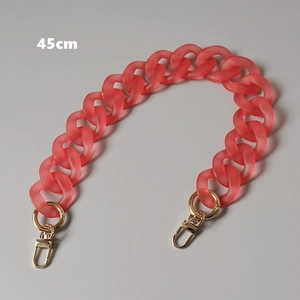 Detail of a 45cm matte red acrylic bag chain with golden metal lobster clasps
