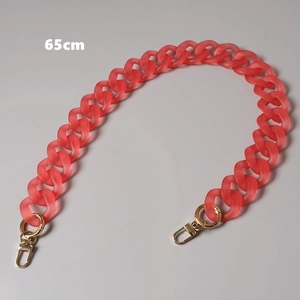 Detail of 65cm matte coral acrylic bag chain with gold lobster clasps on gray backdrop