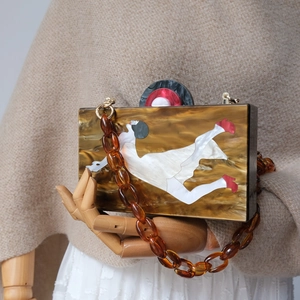 Artistic amber marble acrylic clutch bag with portrait collage and chunky chain strap