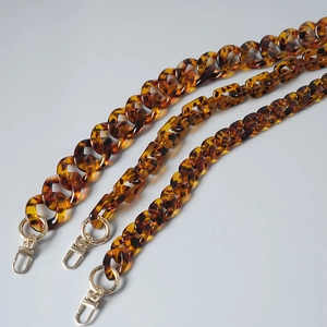 Detail view of vintage leopard resin bag chains with golden lobster metal clasps