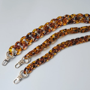 Detailed view of leopard print acrylic bag chains with vintage amber tortoise texture