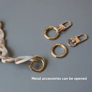 Detail view of marble acrylic chain with openable gold metal spring rings and lobster clasps
