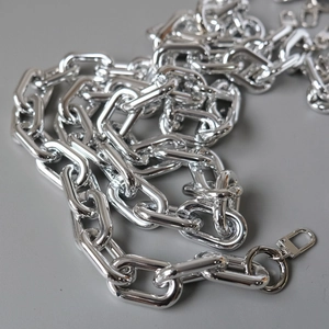 Close-up of thick silver metal chain strap with lobster clasps for shoulder bags