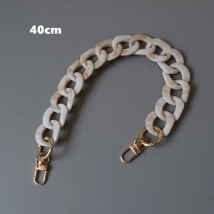 Detail view of a 40cm cream marble resin chain strap with gold metal lobster clasps