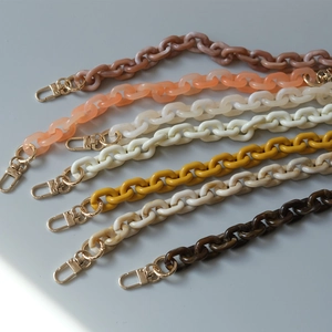 Detail of colorful resin acrylic handbag chains with golden metal lobster clasps