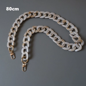 Detail of 80cm acrylic bag strap with beige ink marble texture and gold lobster clasps