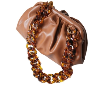 Vintage brown leather pouch bag with amber leopard resin chain strap on white background